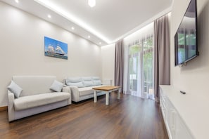 Deluxe Apartment (A1) | Living room | Flat-screen TV
