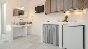 A modern kitchen with white cabinetry, a built-in oven, and a small refrigerator. - Casa Verde di Naxos (Naxos)