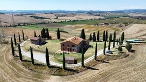 A rural property with a large house surrounded by a fence, a small barn, and a swimming pool. - STAFFOLINO Apartment 1                                        (siena)