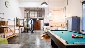 A modern interior with a pool table, a staircase, and a kitchen area. - Dream Aparts - Lofty Scheiblera (Lodz)