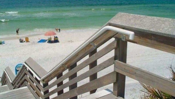 A wooden staircase leading to a beach with a clear view of the ocean. - Moon Pie | Steps to the Beach (Santa Rosa Beach)