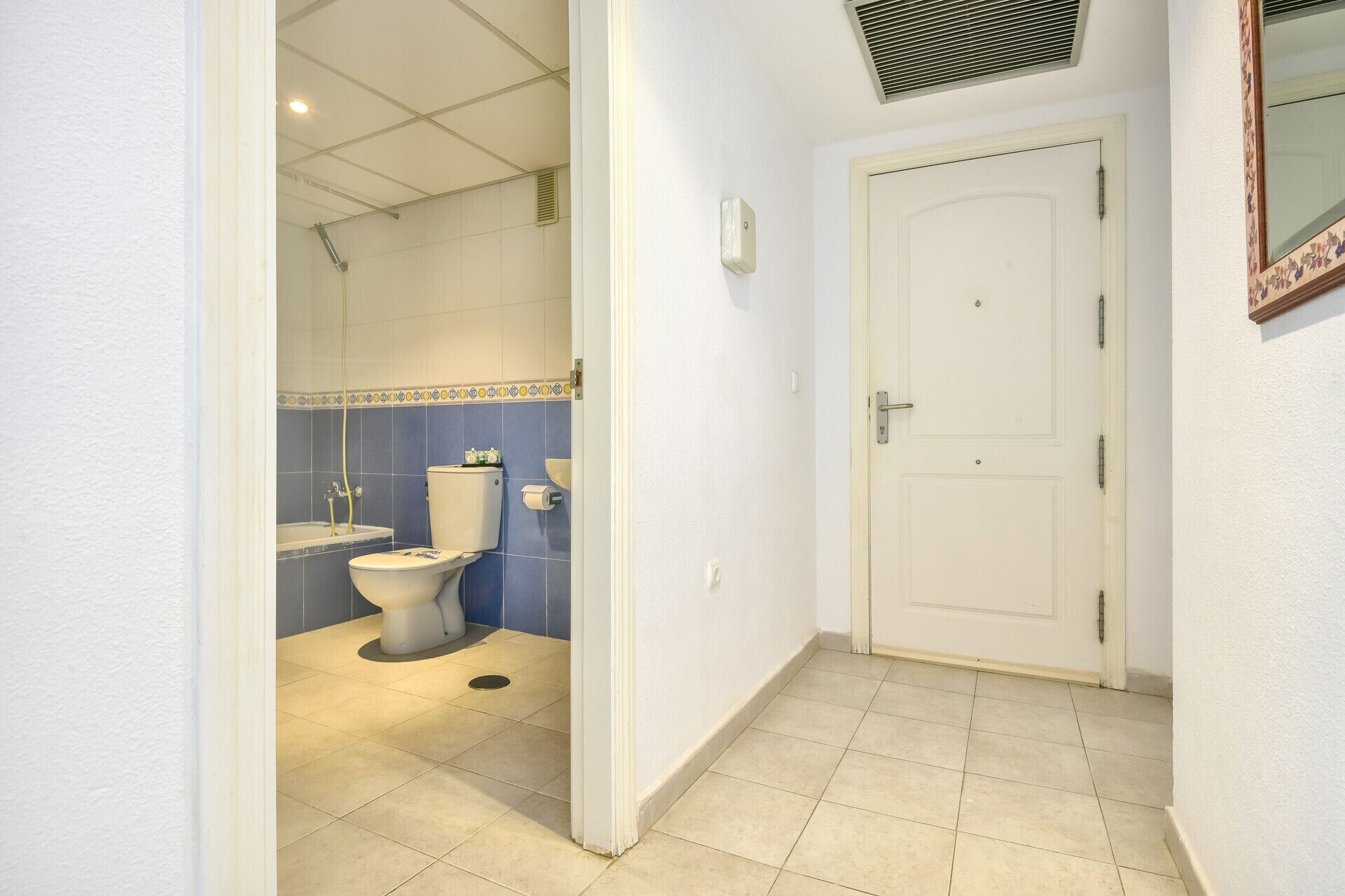 A bathroom with a toilet, sink, and shower.