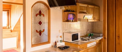Apartment, Garden View | Living room | Flat-screen TV