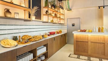 A kitchen with wooden cabinets, a white countertop, and various food items.