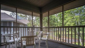 A covered porch with a view of a house and trees. - Teal Lake 2323 (North Myrtle Beach)