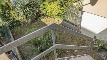 A metal staircase with a metal railing leading to a building.