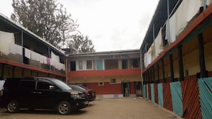 A building with a sign reading "ROKAS HOTEL" and a paved courtyard. - Rokas Hotel (Migori)