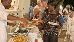 A buffet setup with various food items and utensils.