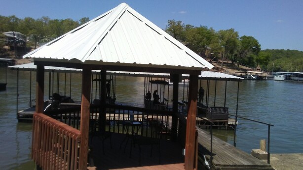 A gazebo with a metal roof and wooden railings overlooking a body of water. - Family Lake View Home - with Dock Access  (Sunrise Beach)