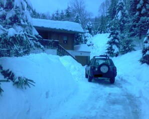 A vehicle parked on a snow-covered road with a house in the background. - GRAND CHALET 400m FROM THE FOOT OF THE SLOPES LABRESSE-HOHNECK (La Bresse)