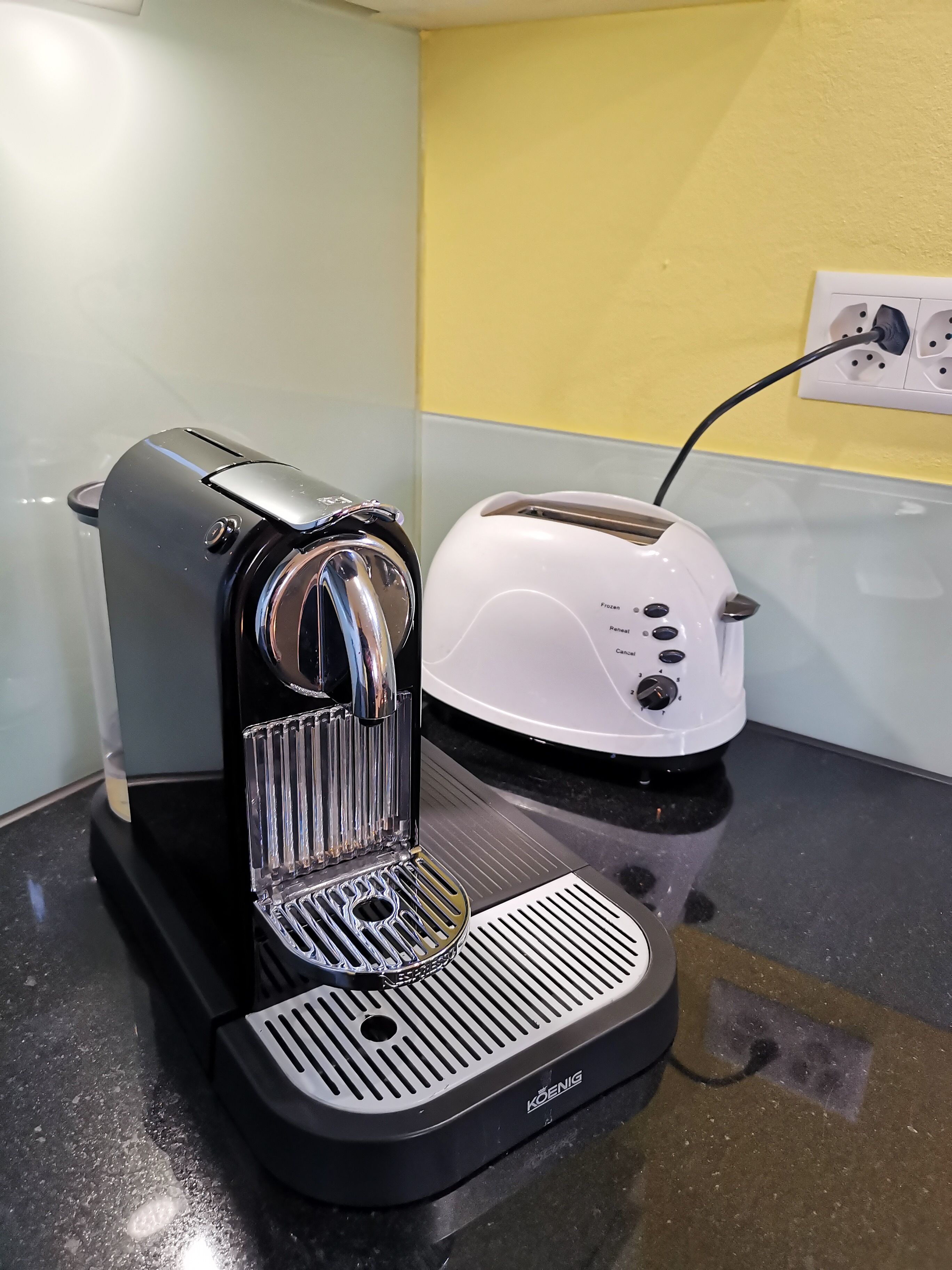 A coffee maker and a toaster on a kitchen counter.