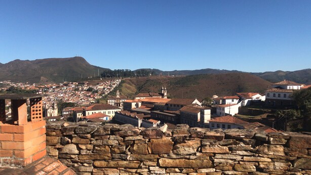 A historic town with stone walls, traditional buildings, and a hilly backdrop. - Diamond Hostel (Ouro Preto)