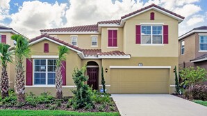 A two-story house with a beige facade, red shutters, and a brown roof. - Star Wars & Princess Themed • South-Facing Pool & Spa • Game Room • Gated Resort (Davenport)