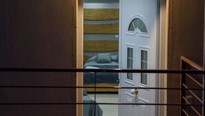 A room with a bed, a door, and a small window. - Artemissoula (Spata-Artemida)