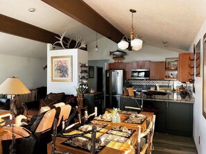 Enjoy meals in this well-appointed dining area with a large table and pendant lights.