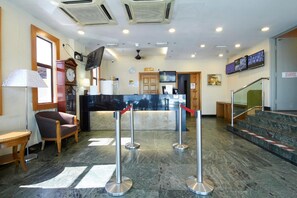A reception area with a counter, seating, and a staircase. - Hotel Kepong (Kuala Lumpur)