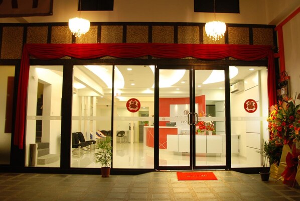 A hotel entrance with a red curtain, glass doors, and a reception desk inside. - Old Penang Hotel - Penang Times Square (George Town)