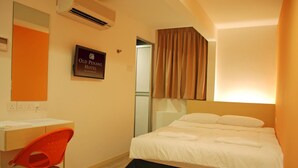 A hotel room with a bed, a desk, a chair, and a sign indicating the hotel name. - Old Penang Hotel - Penang Times Square (George Town)