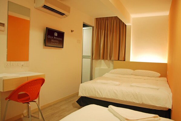 A hotel room with a bed, a desk, a chair, and a sign indicating the hotel name. - Old Penang Hotel - Penang Times Square (George Town)