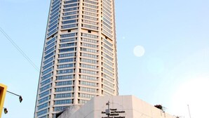 A tall, modern skyscraper with a glass facade and a smaller adjacent building with signage for a jewelry center. - Old Penang Hotel - Penang Times Square (George Town)