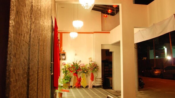 A hallway with chandeliers, a red curtain, and potted plants. - Old Penang Hotel - Penang Times Square (George Town)