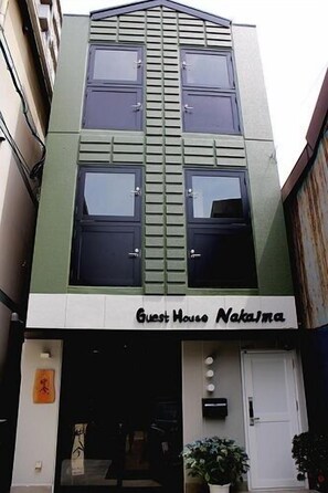 A building with a sign reading 'Guest House Naka'.