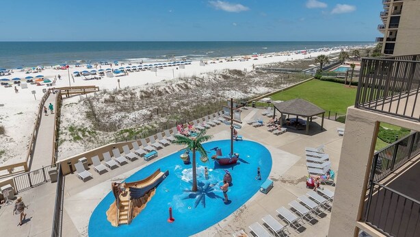 A resort with a pool area, beach access, and a view of the ocean. - One Bedroom 3rd Floor Condo at Phoenix 5 (Orange Beach)