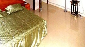 A bedroom with a bed, a television, and a door. - Classy Holiday Villas With Pool in Accra, Ghana (Tema)