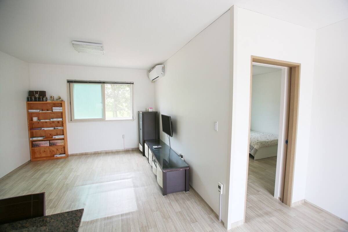 Room, Multiple Beds (104) | Living area | Flat-screen TV, heated floors