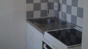 A compact kitchen with a dishwasher, oven, and a sink. - STUDIO by the water with all comfort (Le Havre)