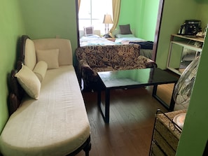 Economy Triple Room | Living area | 40-inch flat-screen TV with satellite channels, TV, DVD player - Guest House Koza Gate 2 (Okinawa)