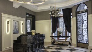 A lobby with a black and white checkered floor, a marble reception desk, and a chandelier. - Azzap Hotel Galata (Istanbul)