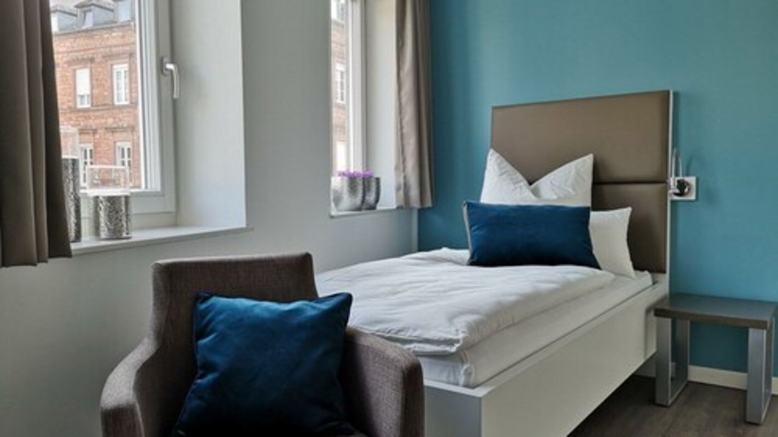 Hypo-allergenic bedding, desk, laptop workspace, blackout drapes