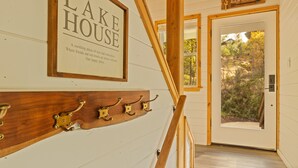 A wooden interior with a sign reading "LAKE HOUSE" and a door leading outside. - Cozy A Frame Cabin, Bass Lake, Ca-Acorn Falls  (Bass Lake)