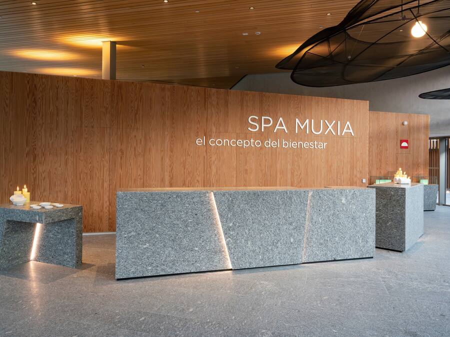 A reception area with a wooden wall and a stone counter.