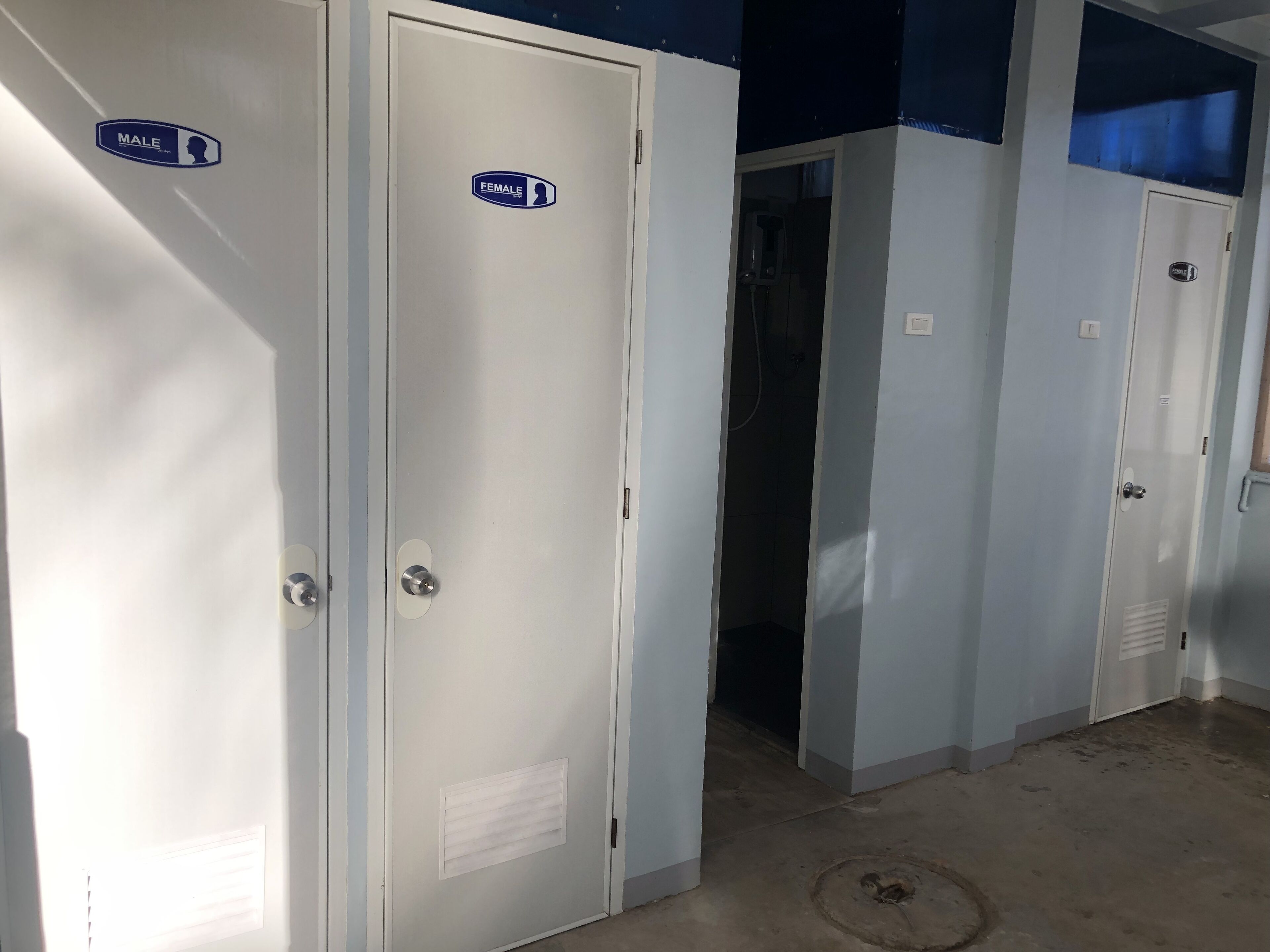 A row of doors with "MALE" and "FEMALE" signs, indicating separate restrooms.