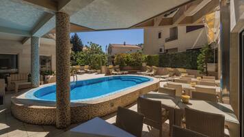 Seasonal outdoor pool, open 11:00 AM to 9:00 PM, pool loungers