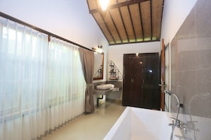 Un baño con bañera, lavamanos y ducha.