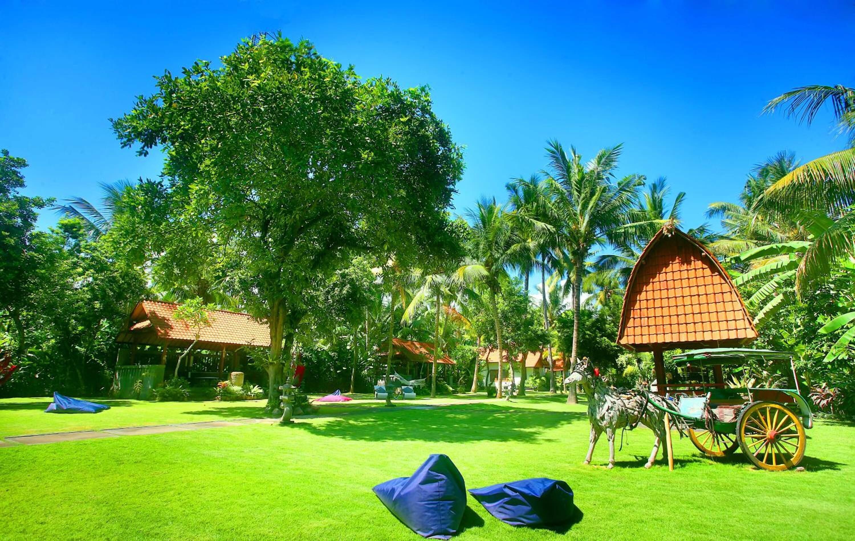A lush garden with a horse-drawn carriage, a gazebo, and a hammock.