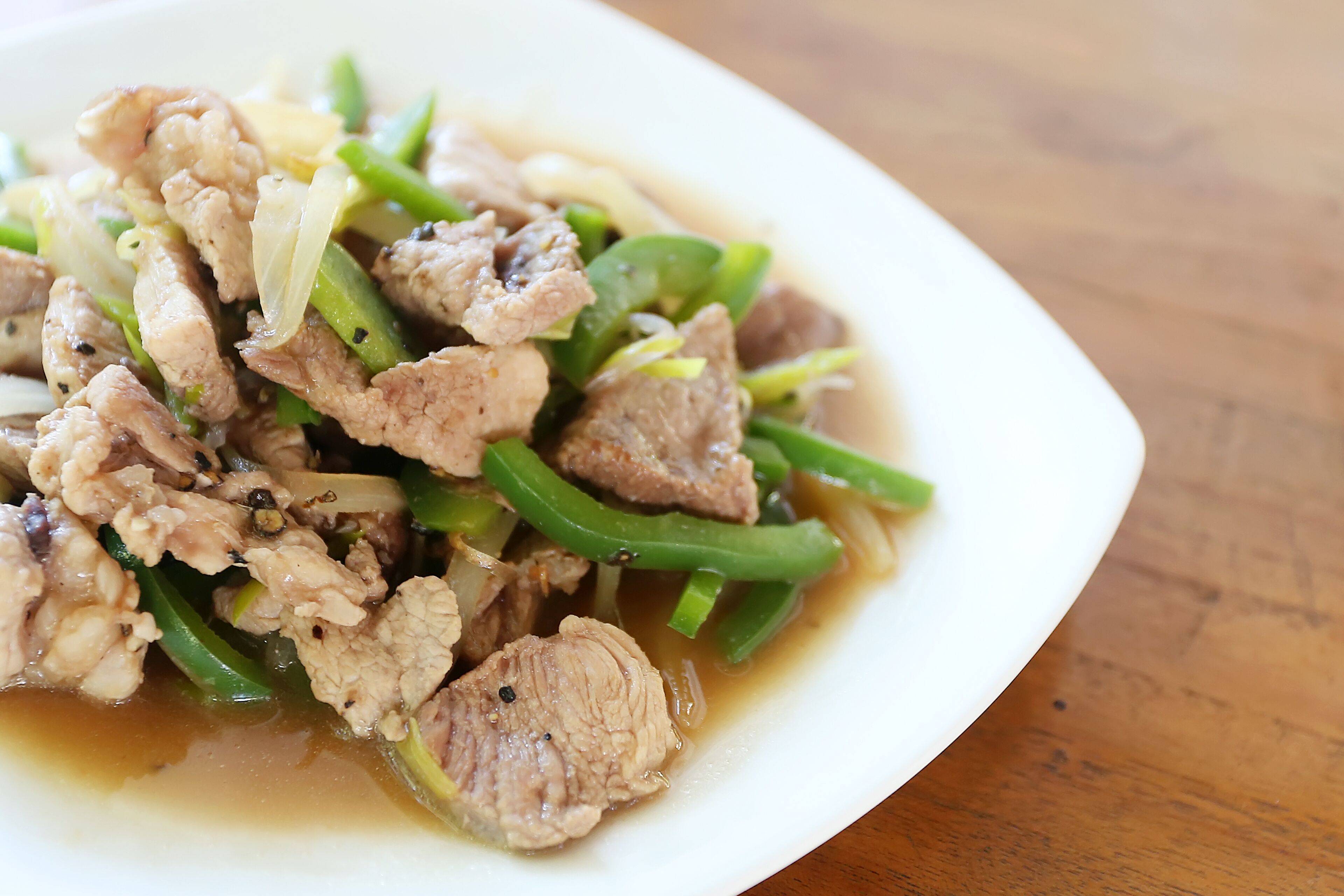 A plate of stir-fried meat and vegetables.