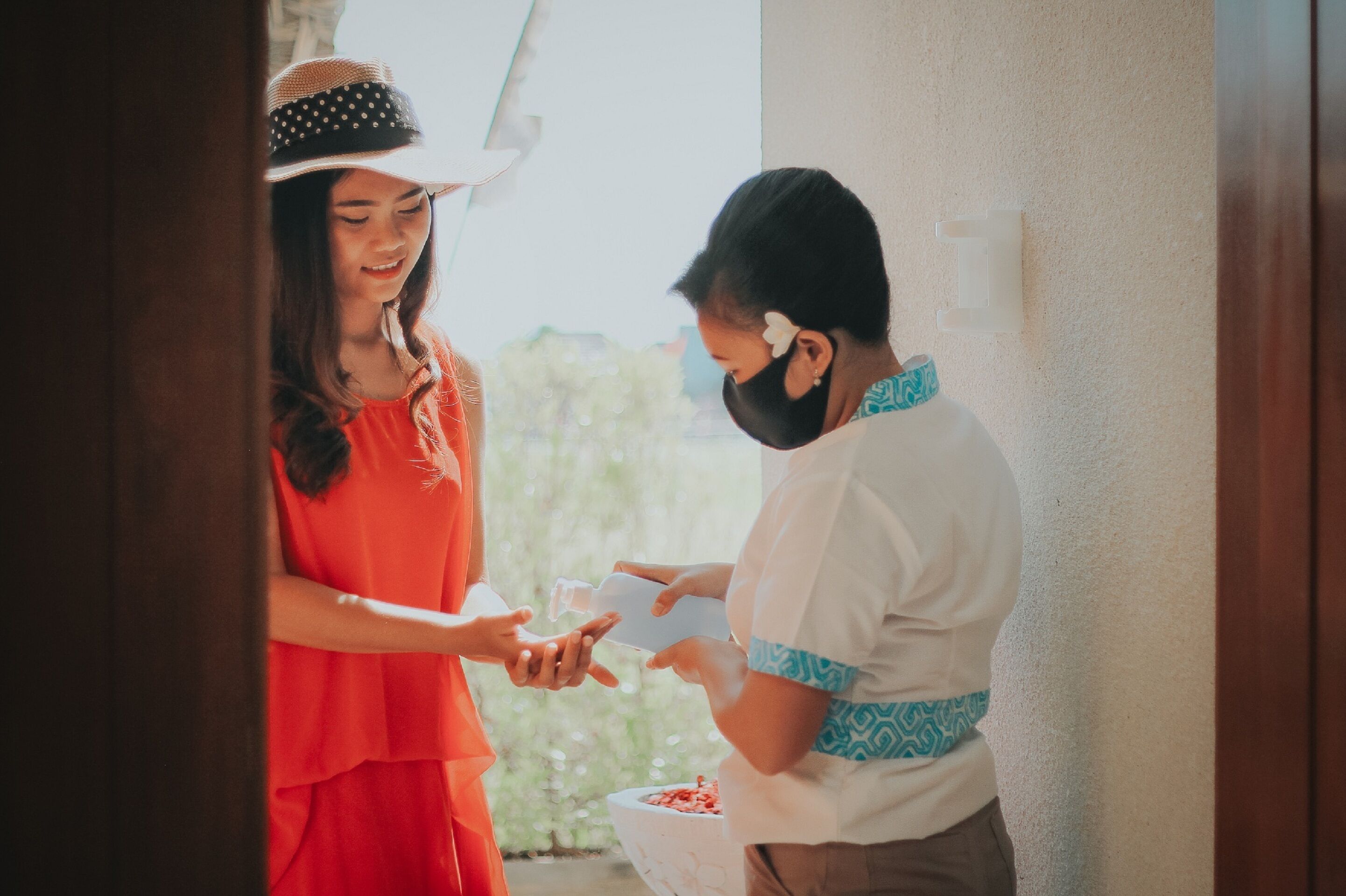 Two people exchanging a bottle of water.