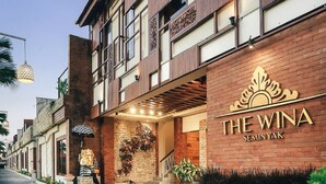 A building with a sign reading "THE WINA SEMINYAK" and a well-lit entrance with a staircase. - The Wina Villa Seminyak (Seminyak)