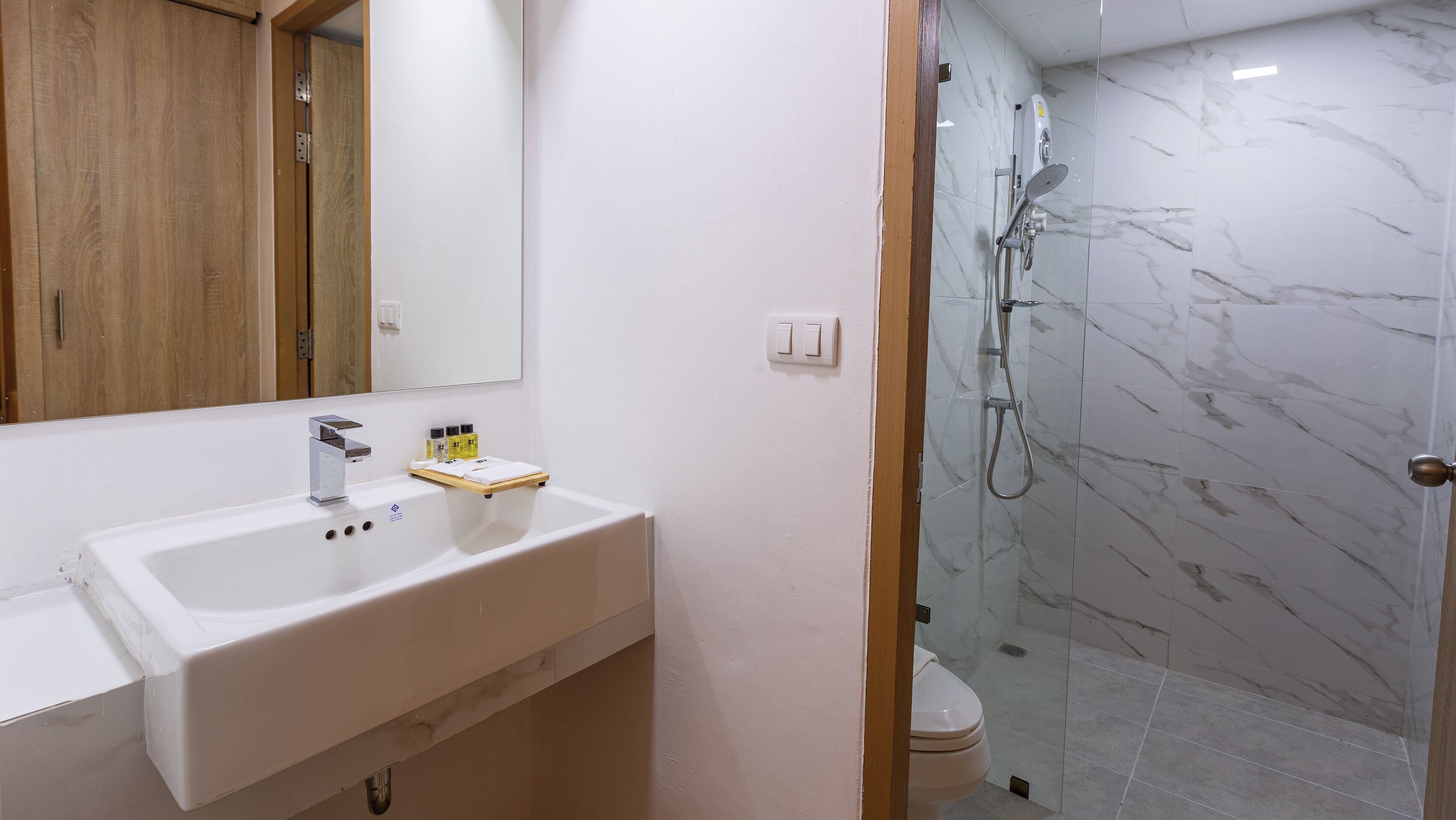 Ein Badezimmer mit Waschbecken, Spiegel und Dusche.