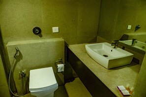 A bathroom with a toilet, sink, and shower. - Hotel Veronica (Vadodara)