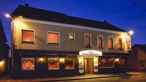 A two-story building with a ground-floor restaurant and upper-floor rooms.
