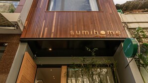 A modern building with a wooden facade and a sign that reads "sumihome". - Sumi Home (Da Nang)