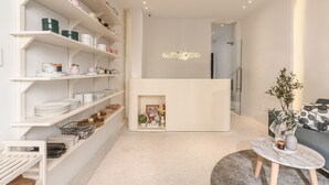 A modern interior with white shelving, a fireplace, and a sofa. - Sumi Home (Da Nang)