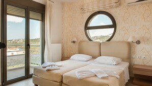 A bedroom with a bed, a window, and a view of the landscape. - Countryside villa with private pool and views (Rethimno)
