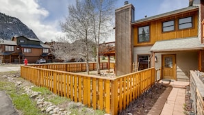 A wooden building with a balcony, a fire hydrant, and a mountain in the background. - PET FRIENDLY Condo close to Main Street in Frisco!! (Frisco)