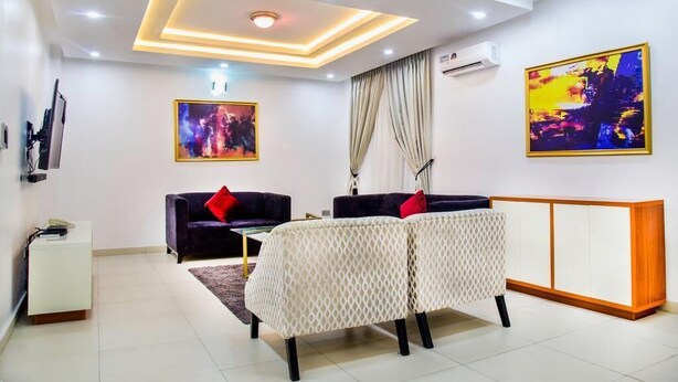 A modern living room with a sofa set, a coffee table, and a cabinet. - Bella Residencia (Lekki)